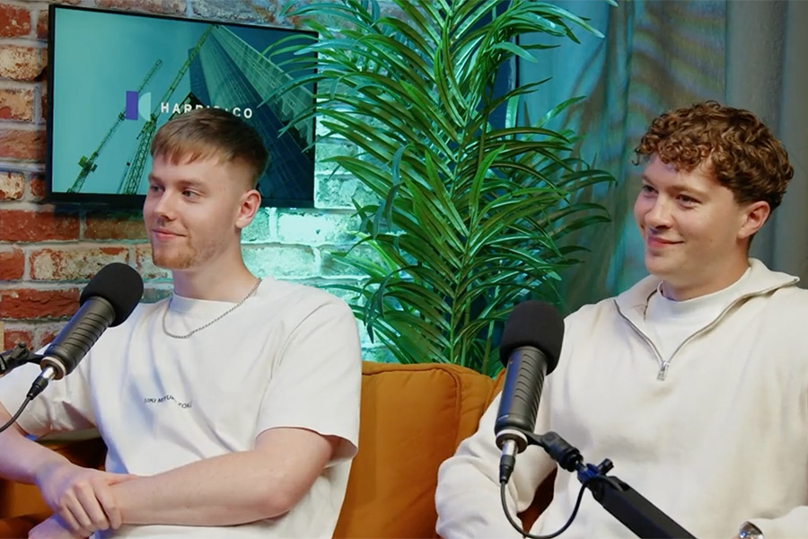 2 male recruitment consultants speaking into podcast mics