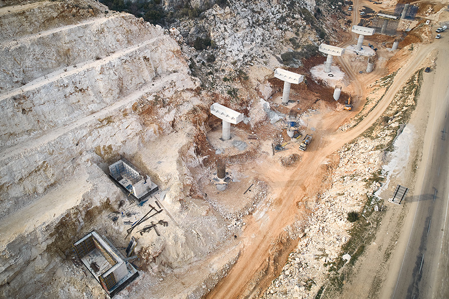 road being constructed on mountain side with diggers