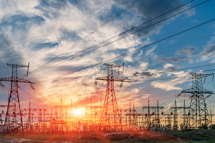 wide shot of sunset sky with power lines and pylons